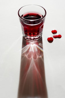 clear drinking glass with red liquid