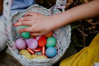 person holding a basket of easter eggs