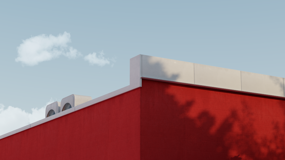 red and white concrete building under white clouds during daytime