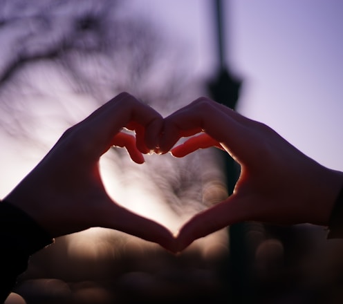 persons hand forming heart