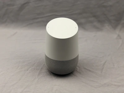 Minimalist smart home device with soft white light on graphite surface.