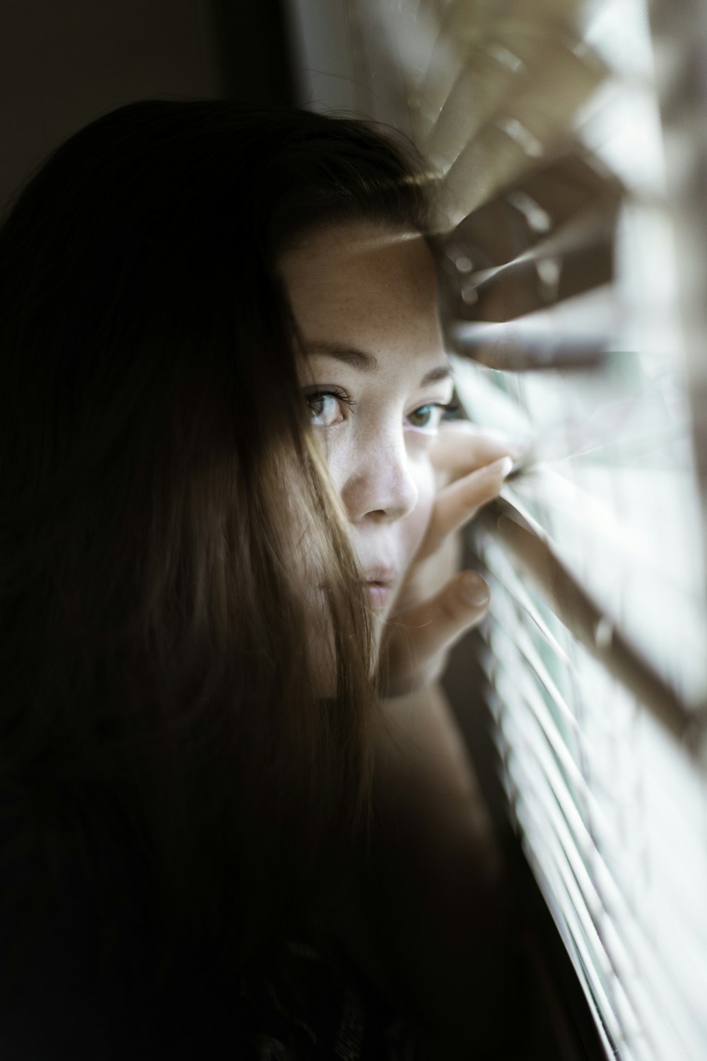 woman looking at the window