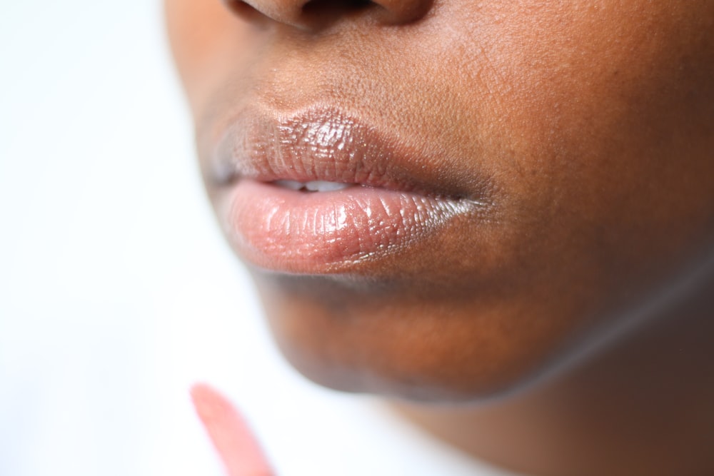 persons face with red lipstick