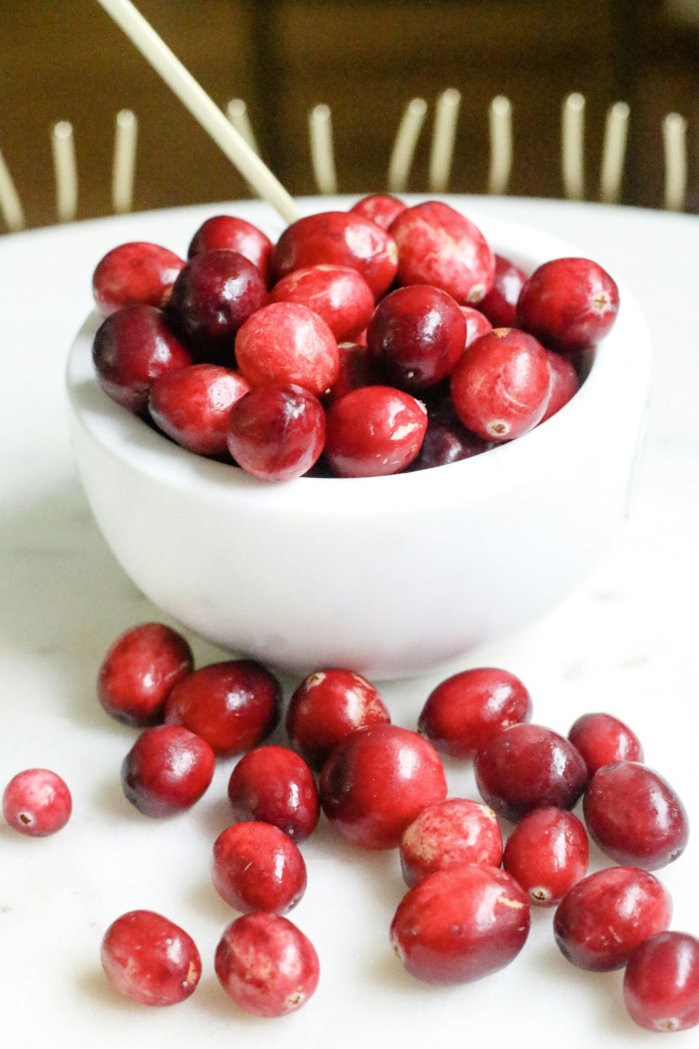 red cherries in white ceramic bowl
