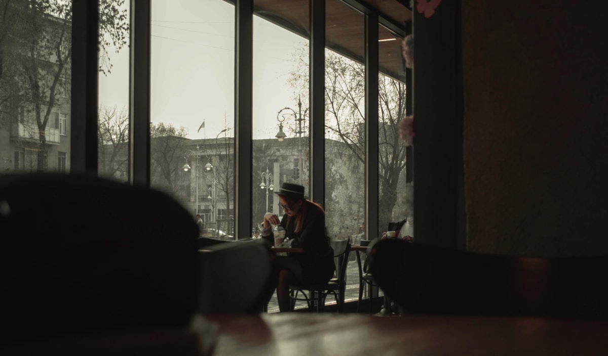 people sitting on chairs near window during daytime