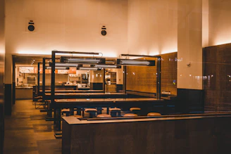 A sleek, minimalist restaurant menu displayed on a wooden table with soft lighting.