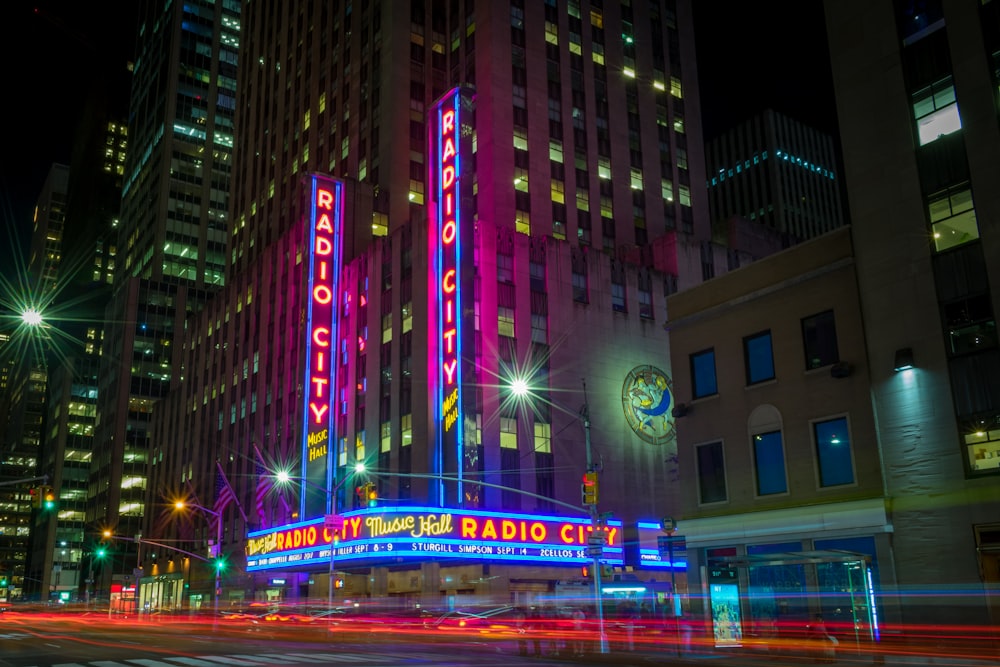 city buildings with lights turned on during night time