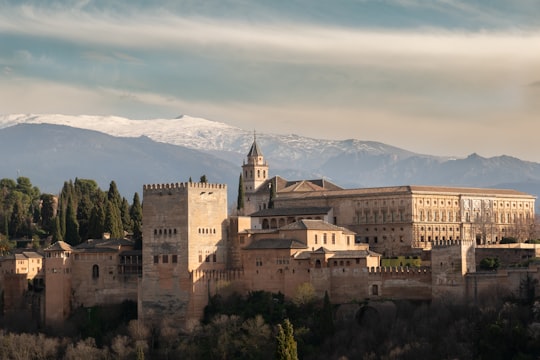 brown concrete castle on top of mountain during daytime in Alhambra Palace Spain