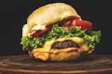 A juicy burger with lettuce, tomato, and melted cheese on a toasted bun.