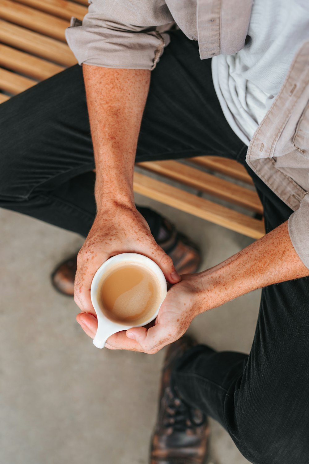 person holding white ceramic mug