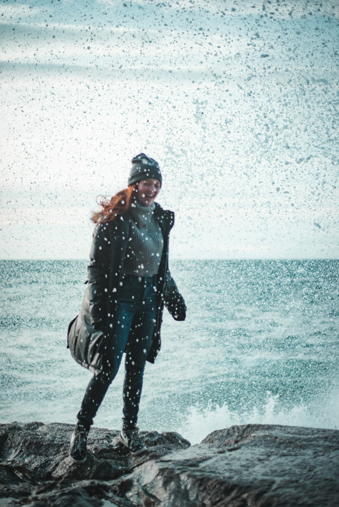 woman in black jacket and black pants standing on water