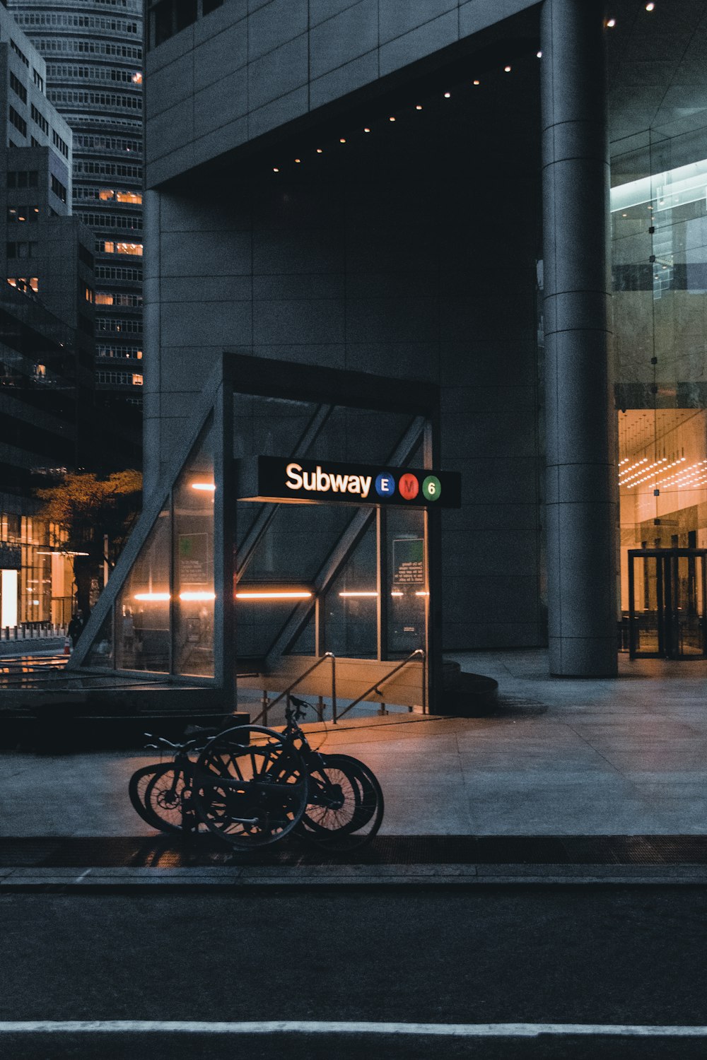 black bicycle parked beside the building during night time