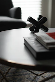 A sleek, modern niddle nest displayed on a minimalist wooden table with monochromatic decor.