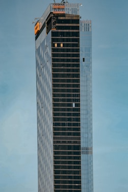 A sleek, modern construction site with clean lines and high-end materials under a clear sky.