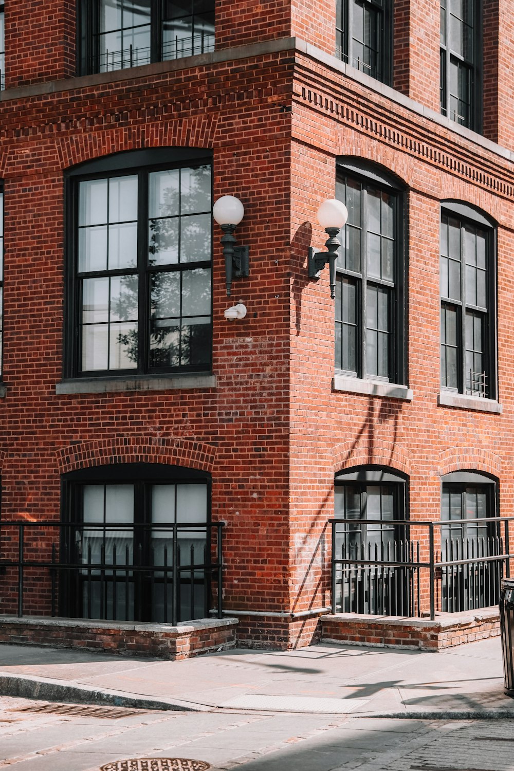 brown brick building with black framed glass window