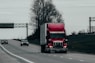 red and white truck on road during daytime