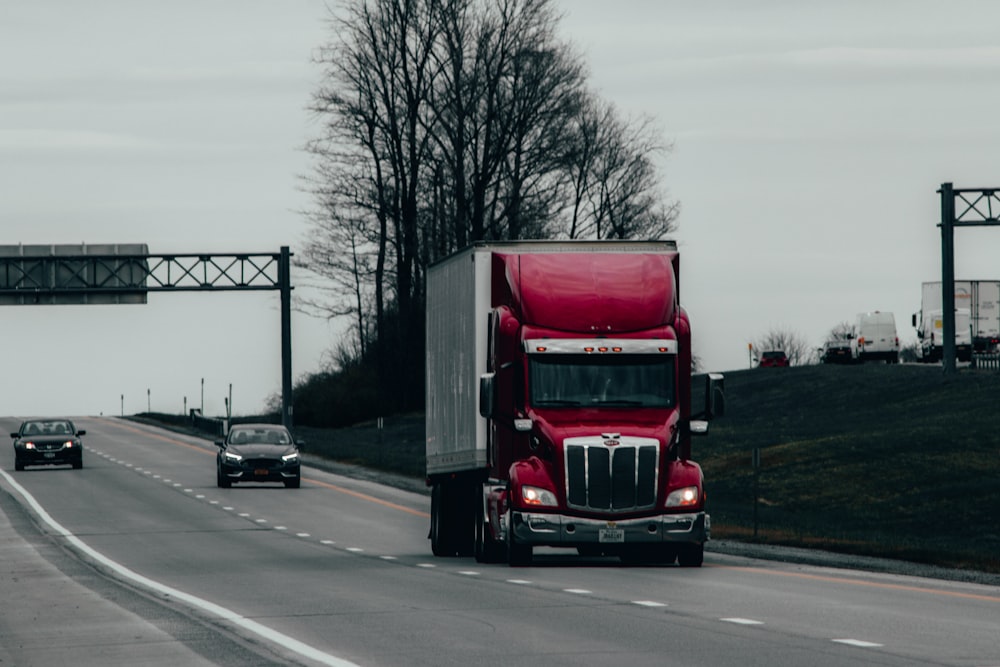 red and white truck on road during daytime