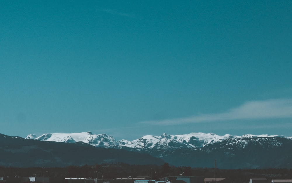 snow covered mountains under blue sky during daytime