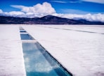 white snow covered ground near body of water during daytime