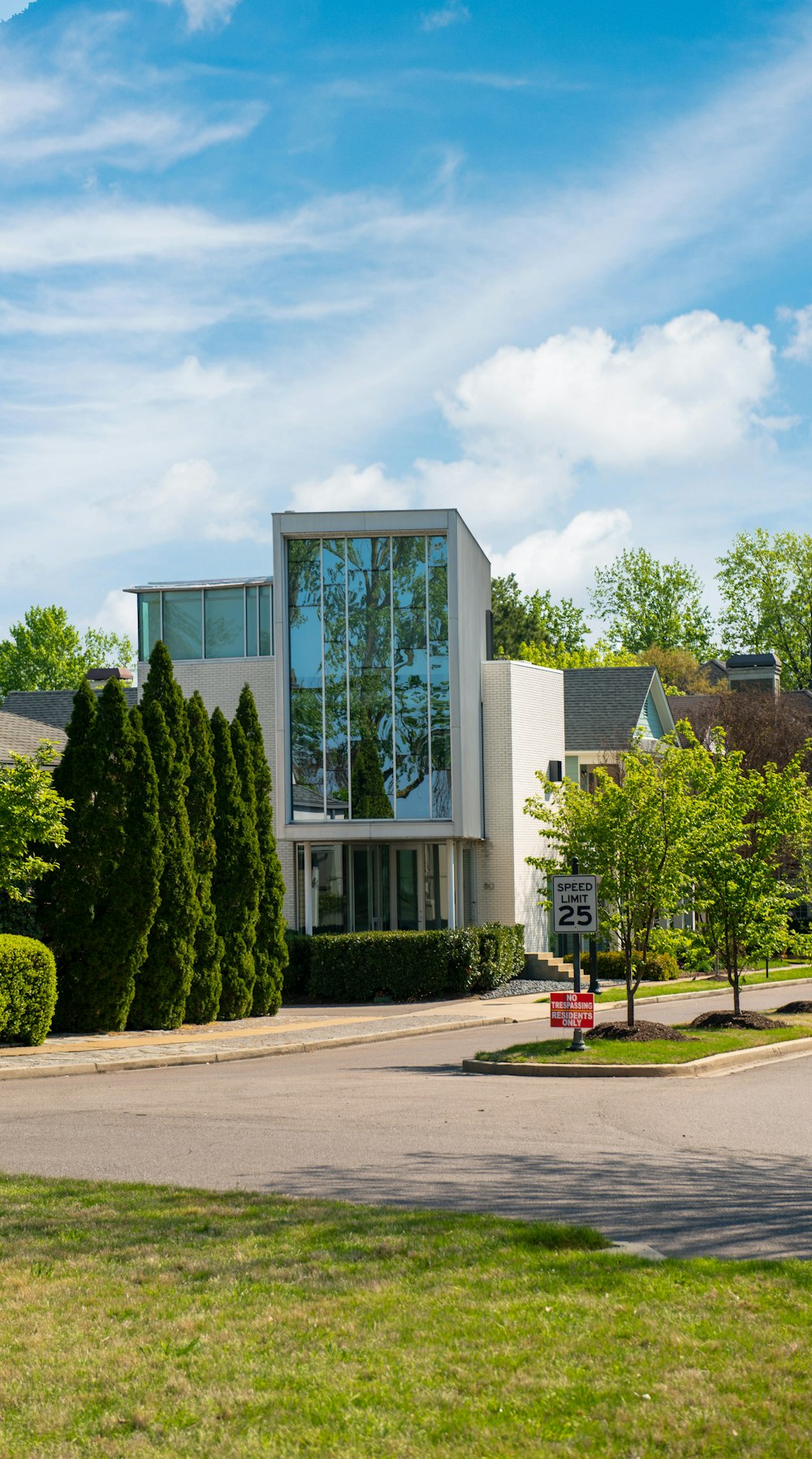 white and brown concrete building near green trees during daytime