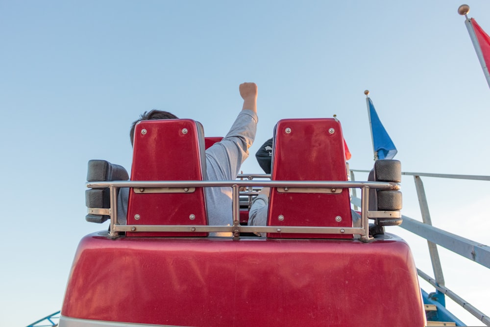 2 men sitting on red chair