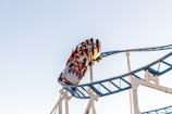 people riding roller coaster during daytime