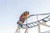 A joyful family enjoying a thrilling roller coaster ride under a bright blue sky.