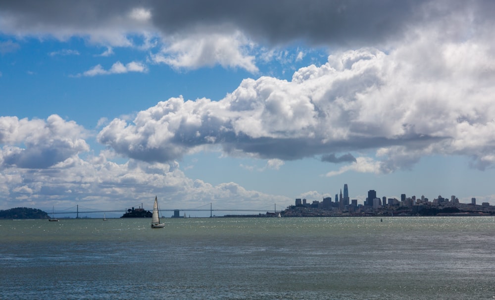 body of water under blue sky and white clouds during daytime