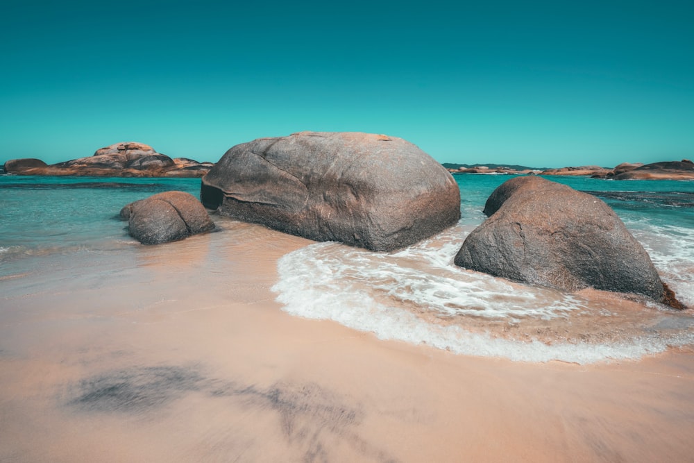 brown rock formation on seashore during daytime