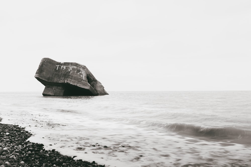 brown rock formation on sea water during daytime