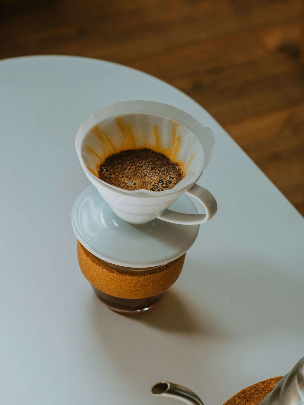 white ceramic cup with brown liquid on white ceramic saucer