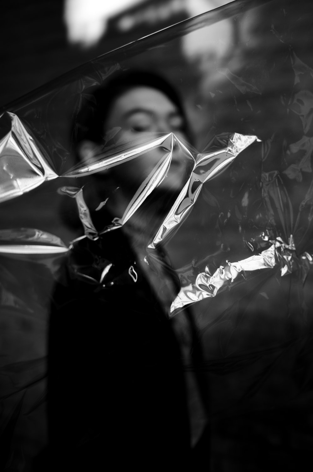 woman in black shirt holding clear plastic bag