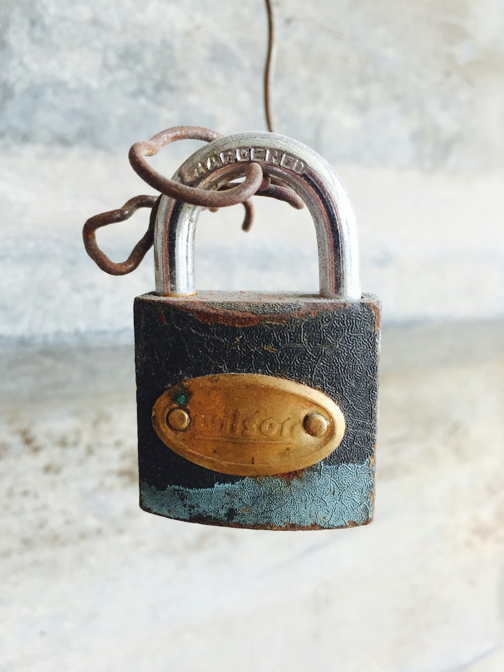 gold padlock on grey metal bar