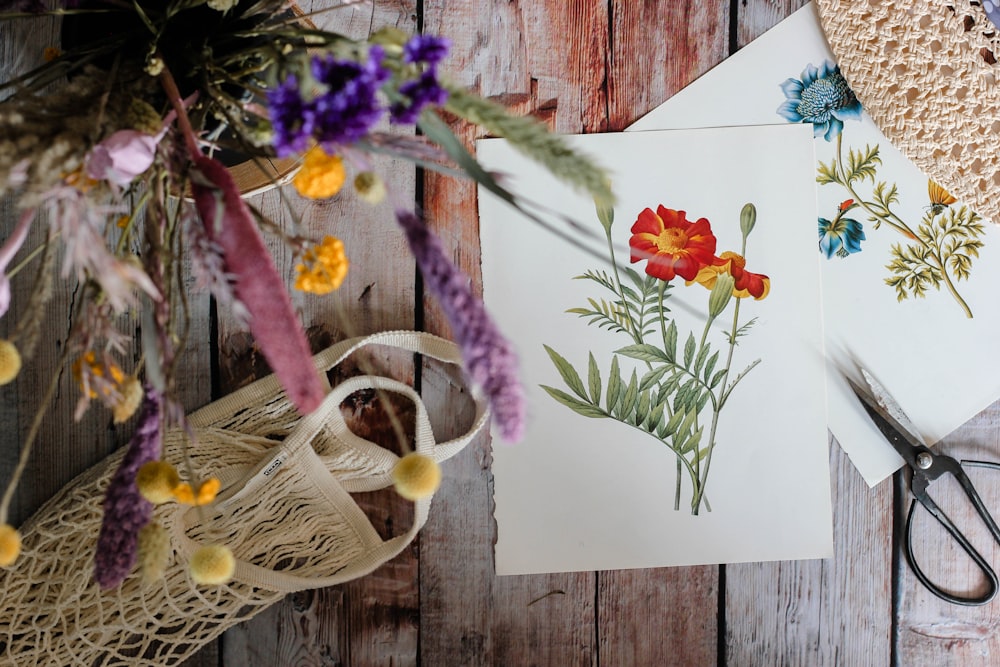 yellow and purple flowers on white wooden table