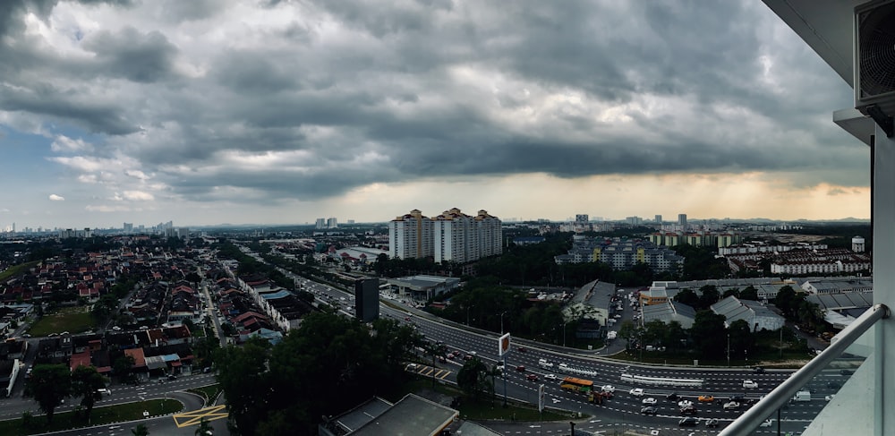 city with high rise buildings under gray clouds during daytime