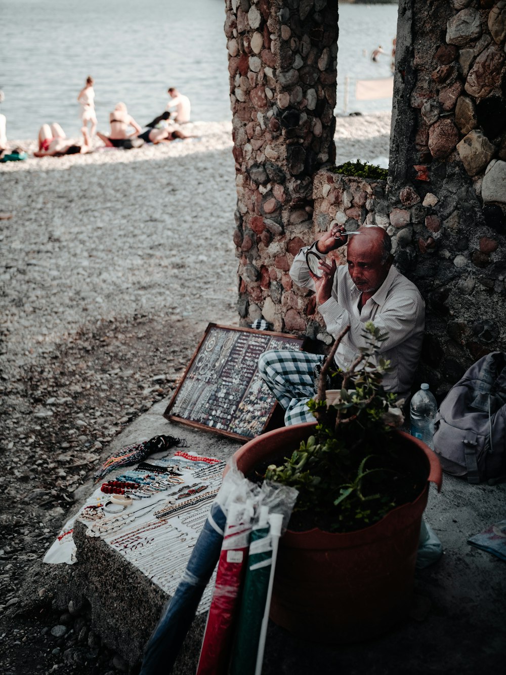 man in white dress shirt sitting on brown wooden bench