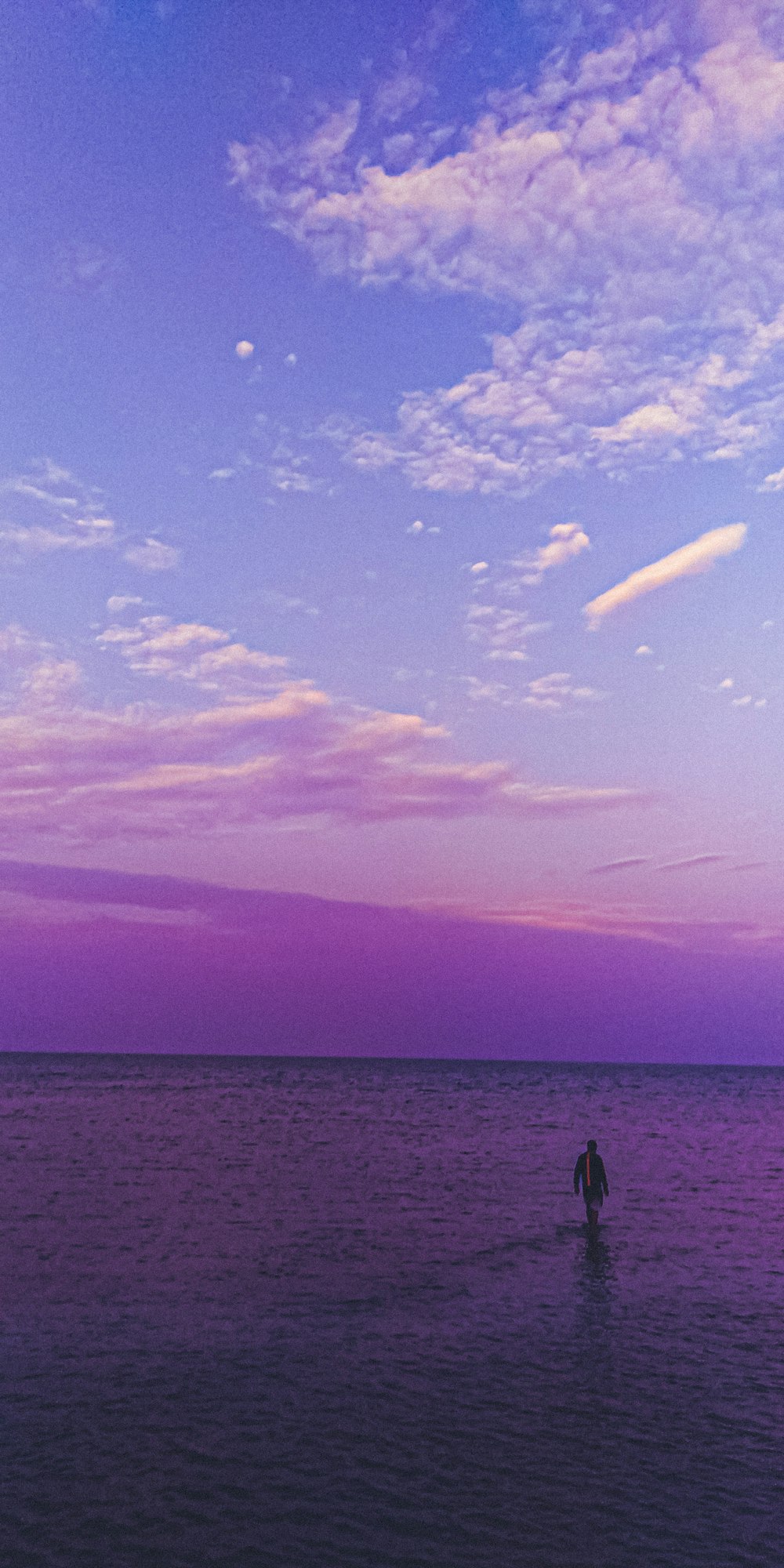 silhouette of person on boat on sea during sunset