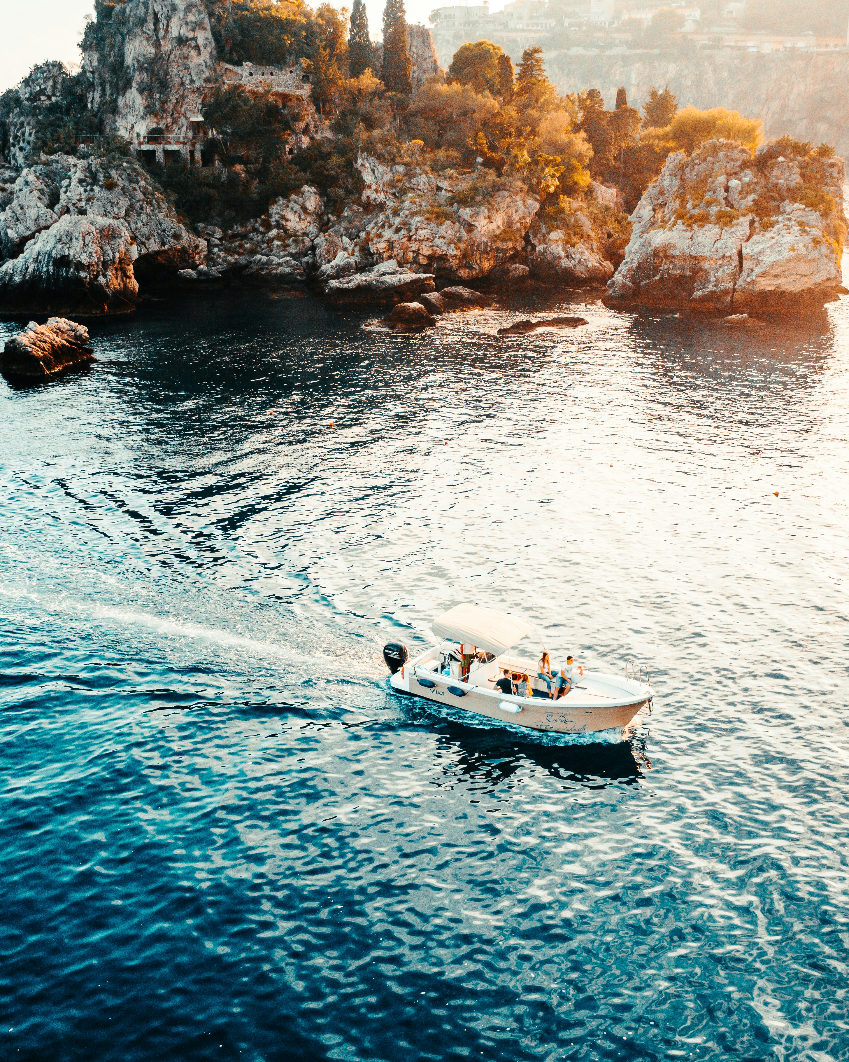 white and black boat on sea during daytime