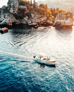 white and black boat on sea during daytime