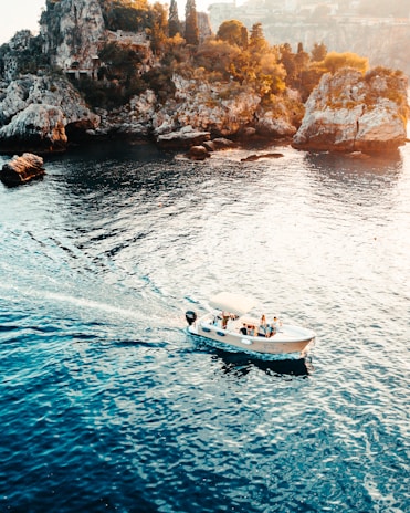 white and black boat on sea during daytime
