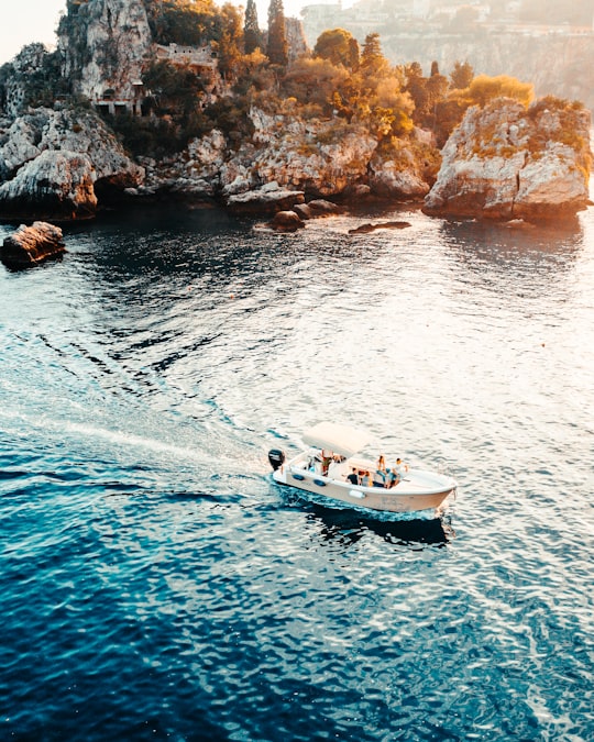 white and black boat on sea during daytime in Isola Bella Italy