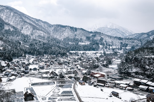 houses near mountain during daytime in Historic Villages of Shirakawa-gō and Gokayama Japan