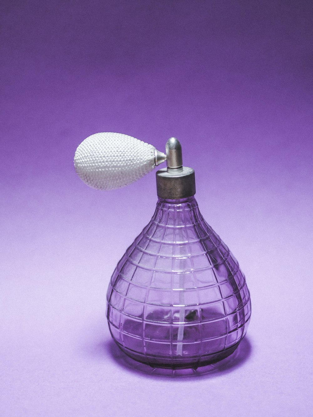 purple and white glass bottle