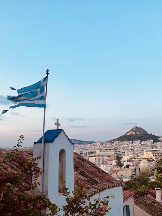 white and blue flag on top of building in Acropolis of Athens Greece