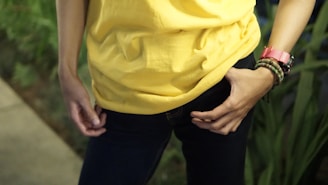 person in yellow shirt and black pants