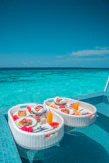 white and red plastic round table with chairs on beach during daytime