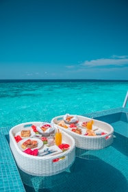 white and red plastic round table with chairs on beach during daytime