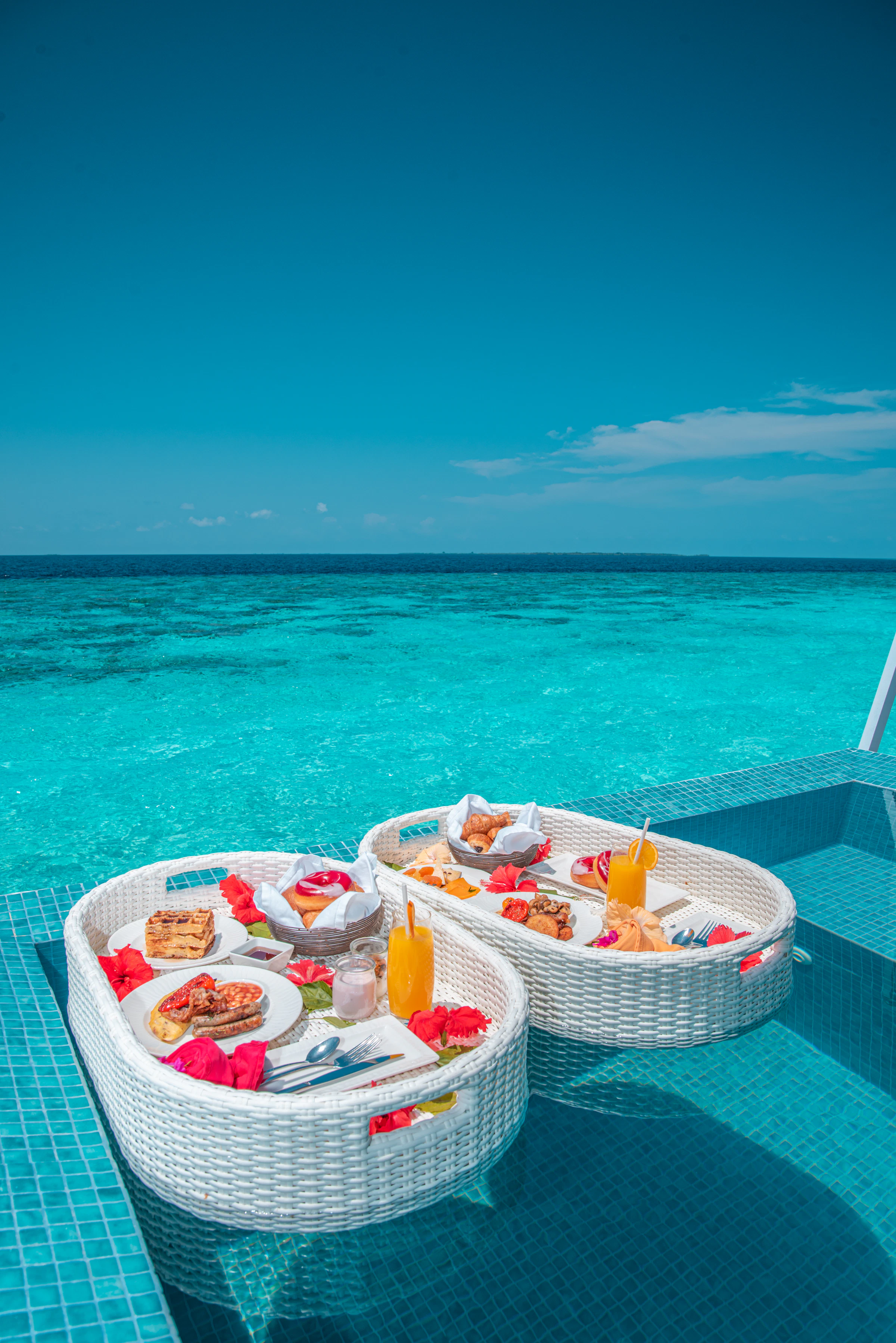 Floating breakfast trays in a turquoise pool