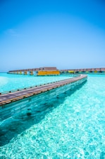 brown wooden dock on blue sea under blue sky during daytime
