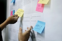 person holding yellow sticky notes